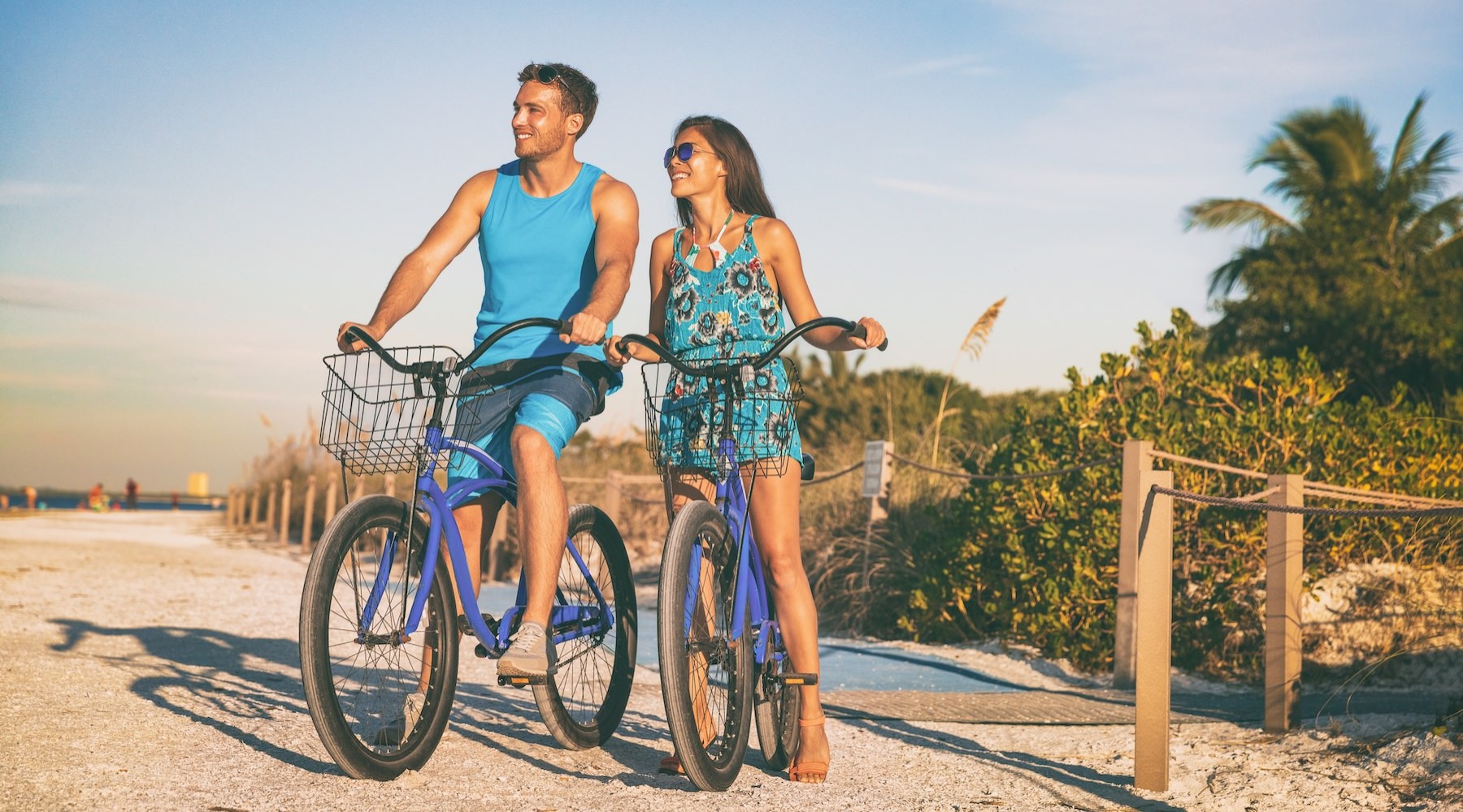 two people with bikes on a beach