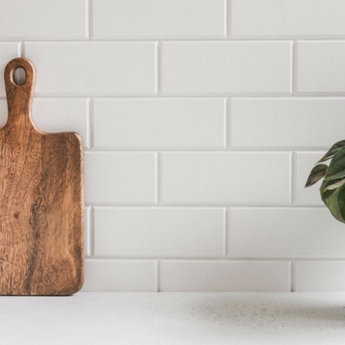 a couple of vases and a plant in a white pot